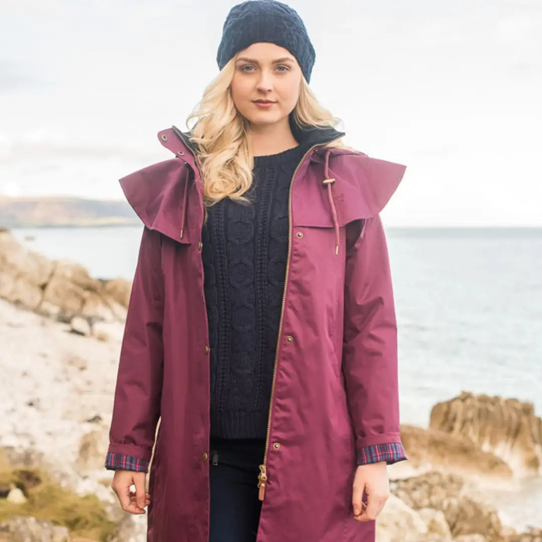 Woman in Burgundy Lighthouse Outback Full Length Ladies Waterproof Raincoat on beach