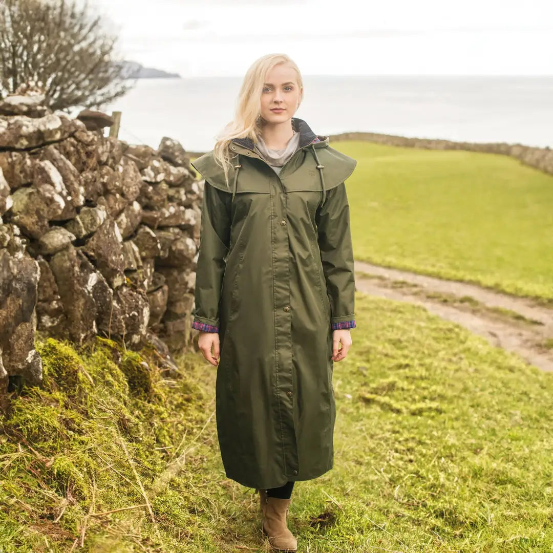 Woman in a Lighthouse Outback full length ladies raincoat in a rural setting