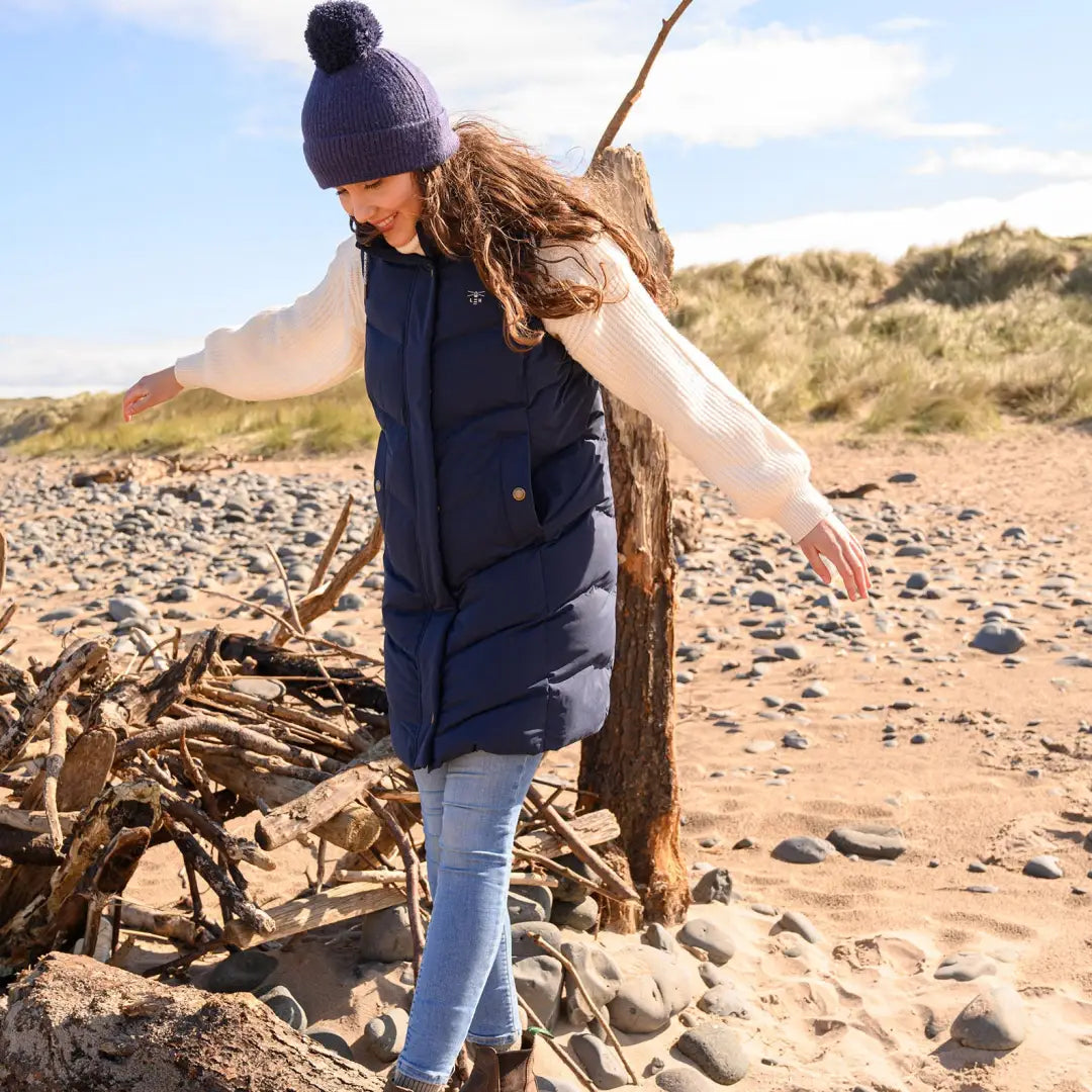 Woman in a navy puffer vest and knit hat, perfect for country clothing outdoors