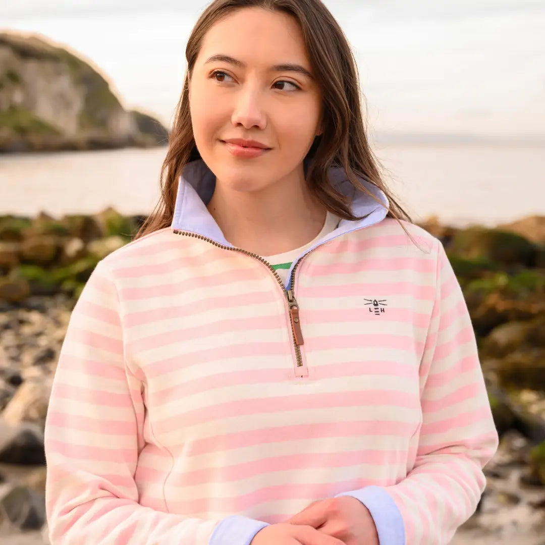 Woman in a pink and white striped Lighthouse Shore cotton jersey sweatshirt