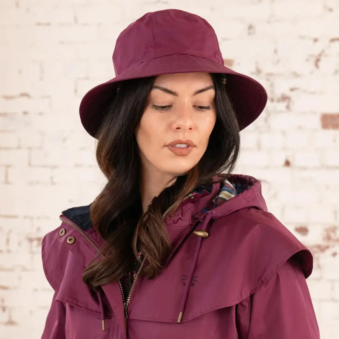 Woman in a burgundy hat and coat showcasing Lighthouse Storm Waterproof Ladies Hat