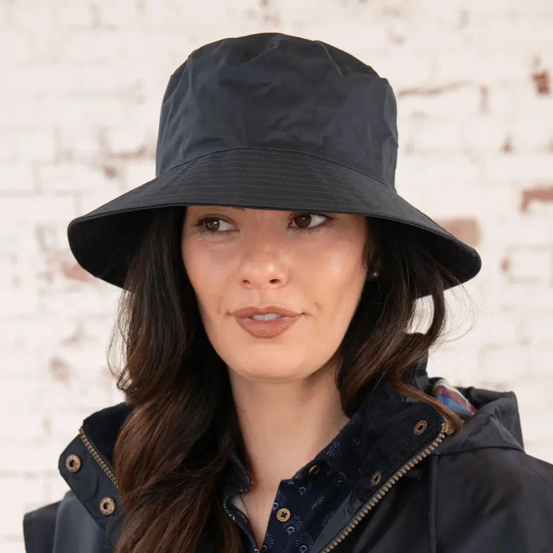 Woman with long dark hair wearing a Lighthouse Storm Waterproof Ladies Hat, black bucket style