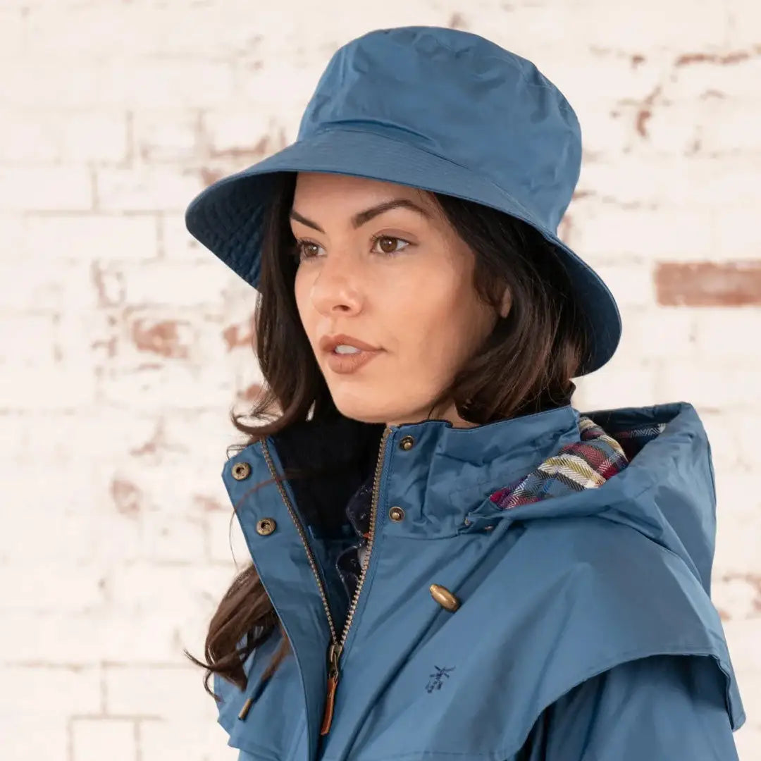 Woman with long dark hair wearing a Lighthouse Storm Waterproof Ladies Hat in blue