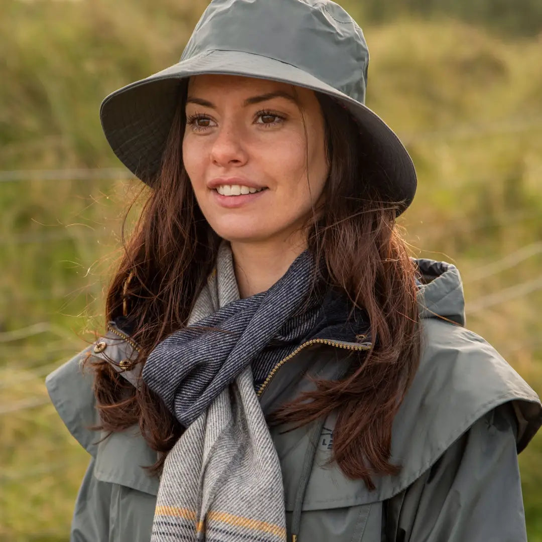 Woman in gray hat and jacket sporting the Lighthouse Storm Waterproof Ladies Hat