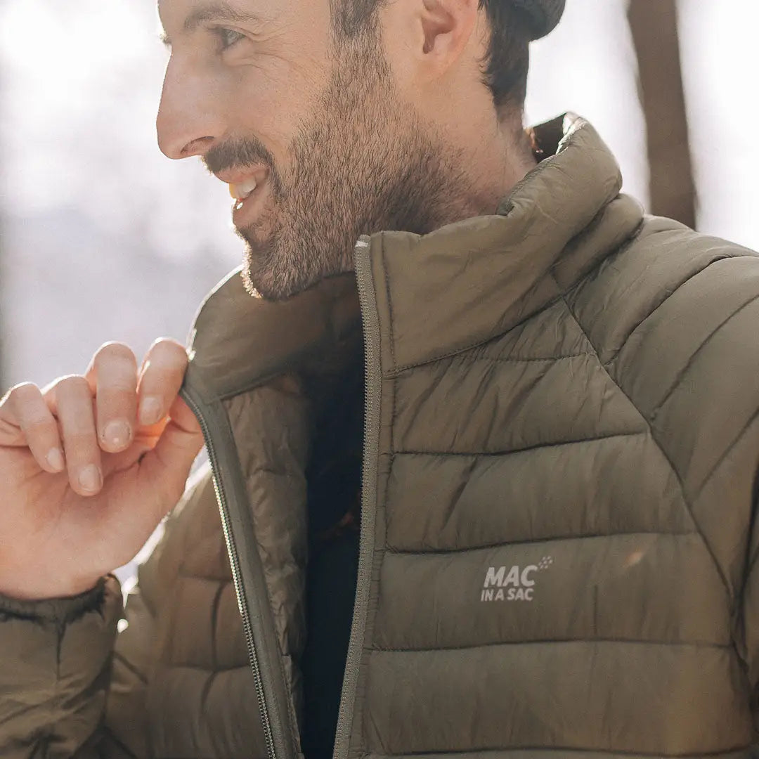 Smiling person in an Olive green MAC puffy jacket, perfect for country clothing and outdoors