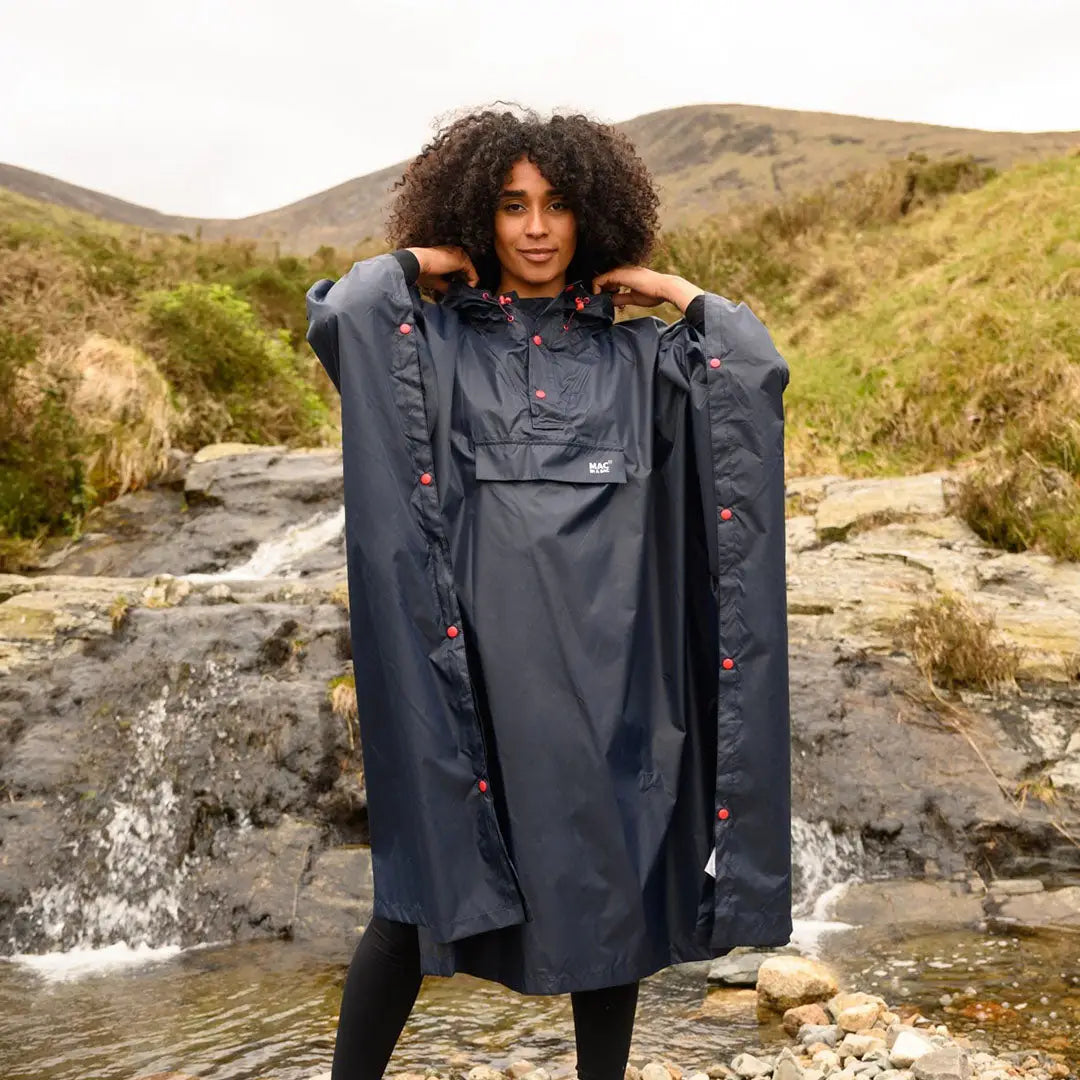 Waterproof Mac In A Sac Origin 2 Poncho with floral embroidery by a stream in country clothing