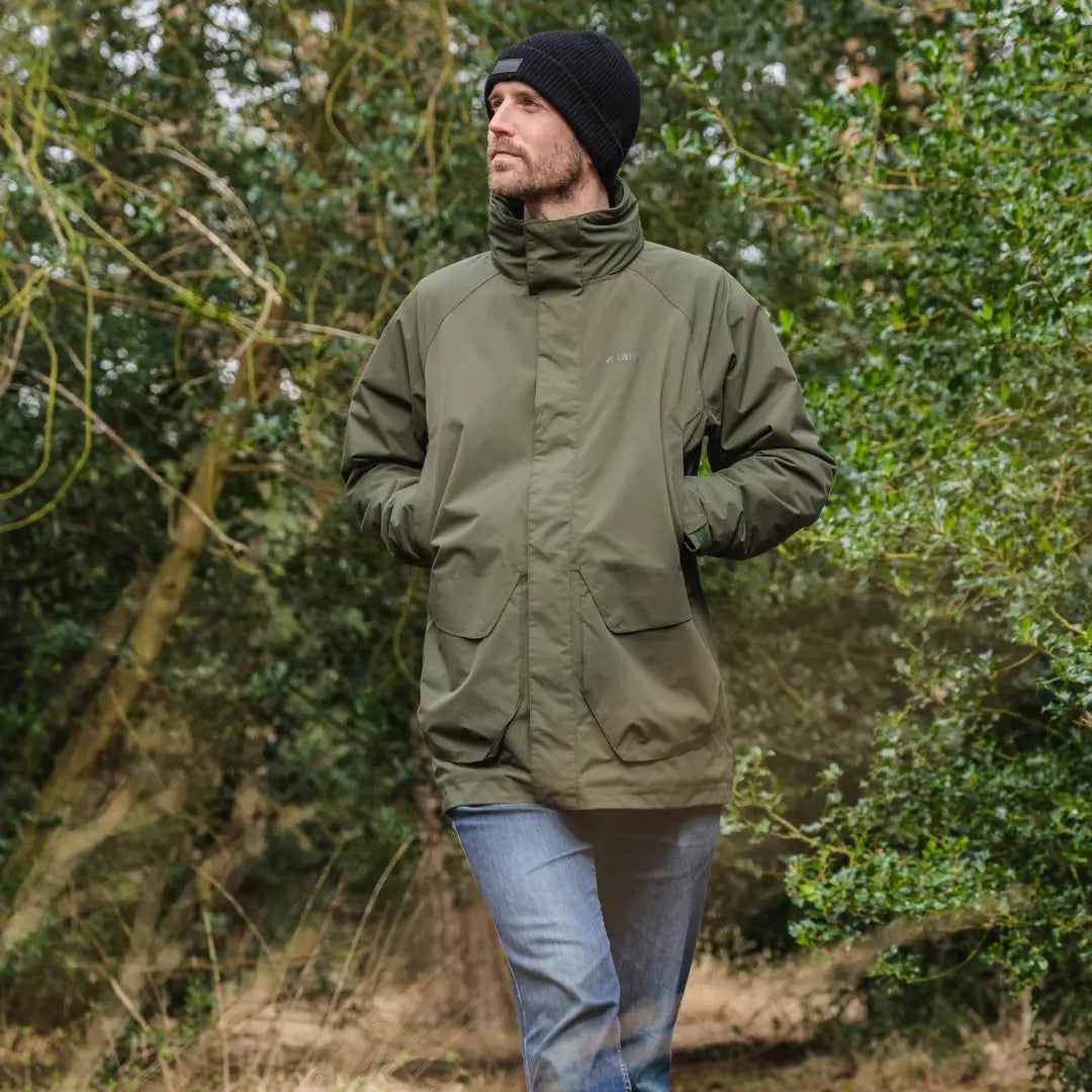 Olive green Musto Fenland Primaloft Jacket in an outdoor setting, stylish and waterproof