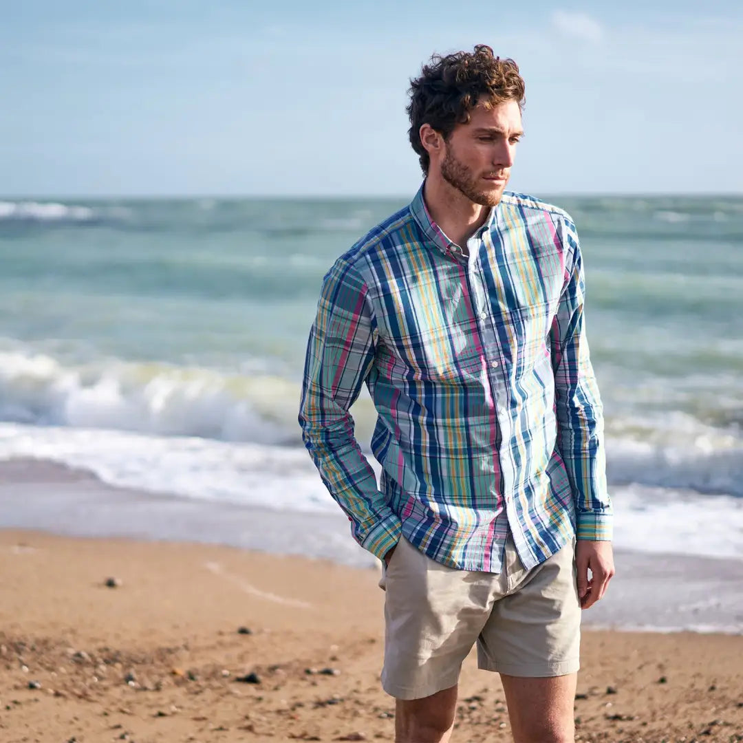 Man in Musto Marina Plaid Long Sleeve Shirt and khaki shorts on the beach