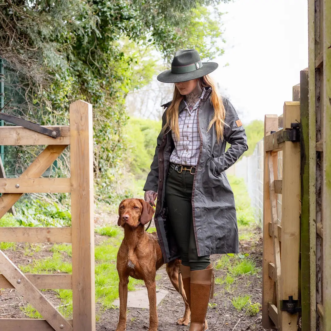 Woman in country attire with brown dog near wooden gate in Forest Alice Waterproof Coat