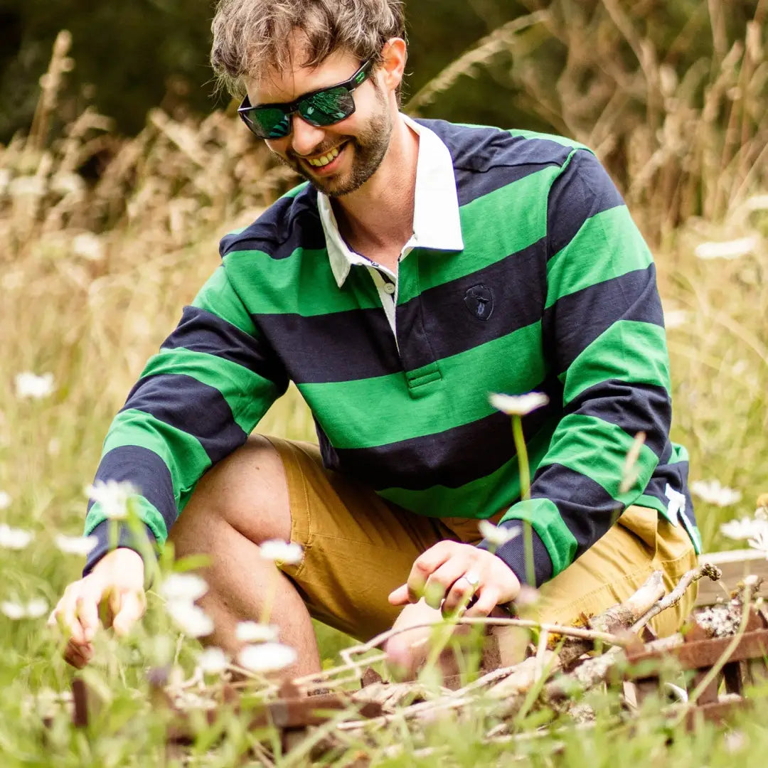 Man in striped rugby shirt and sunglasses wearing Forest Chino Shorts in a field