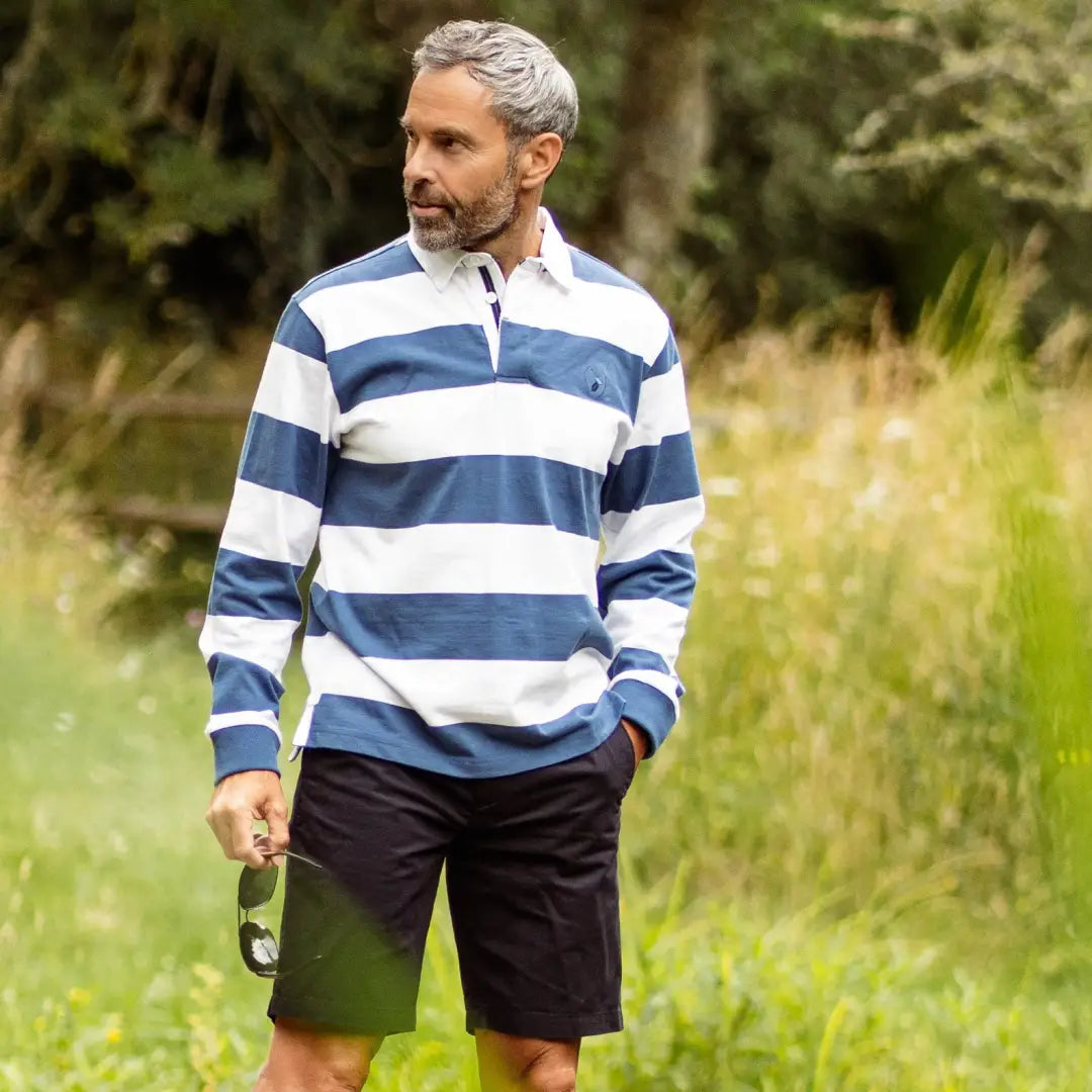 Man in New Forest Classic Stripe Rugby Shirt and dark shorts, ready for action