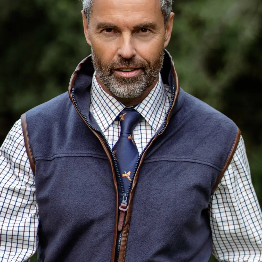 Middle-aged man in navy Forest Fleece Gilet over checked shirt and tie