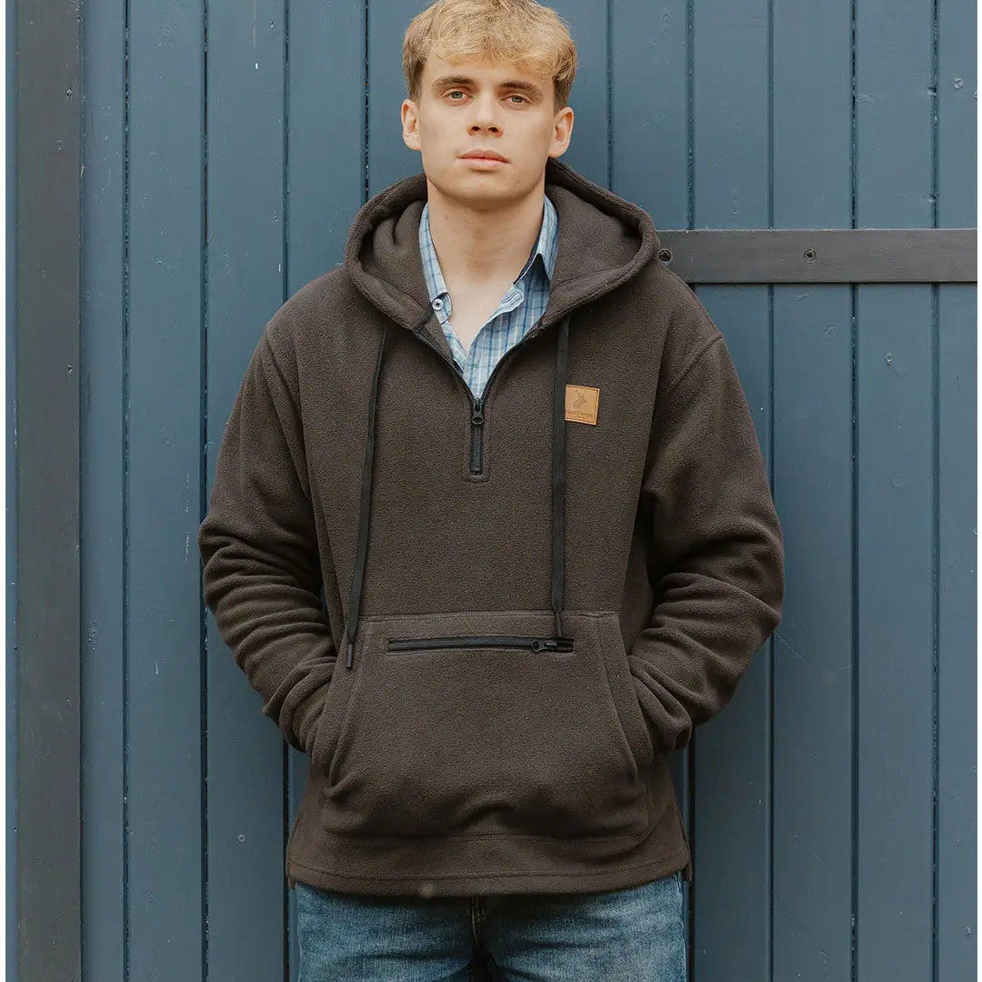 Young man rocking a Forest Heathland Hoodie with blue jeans in a casual style