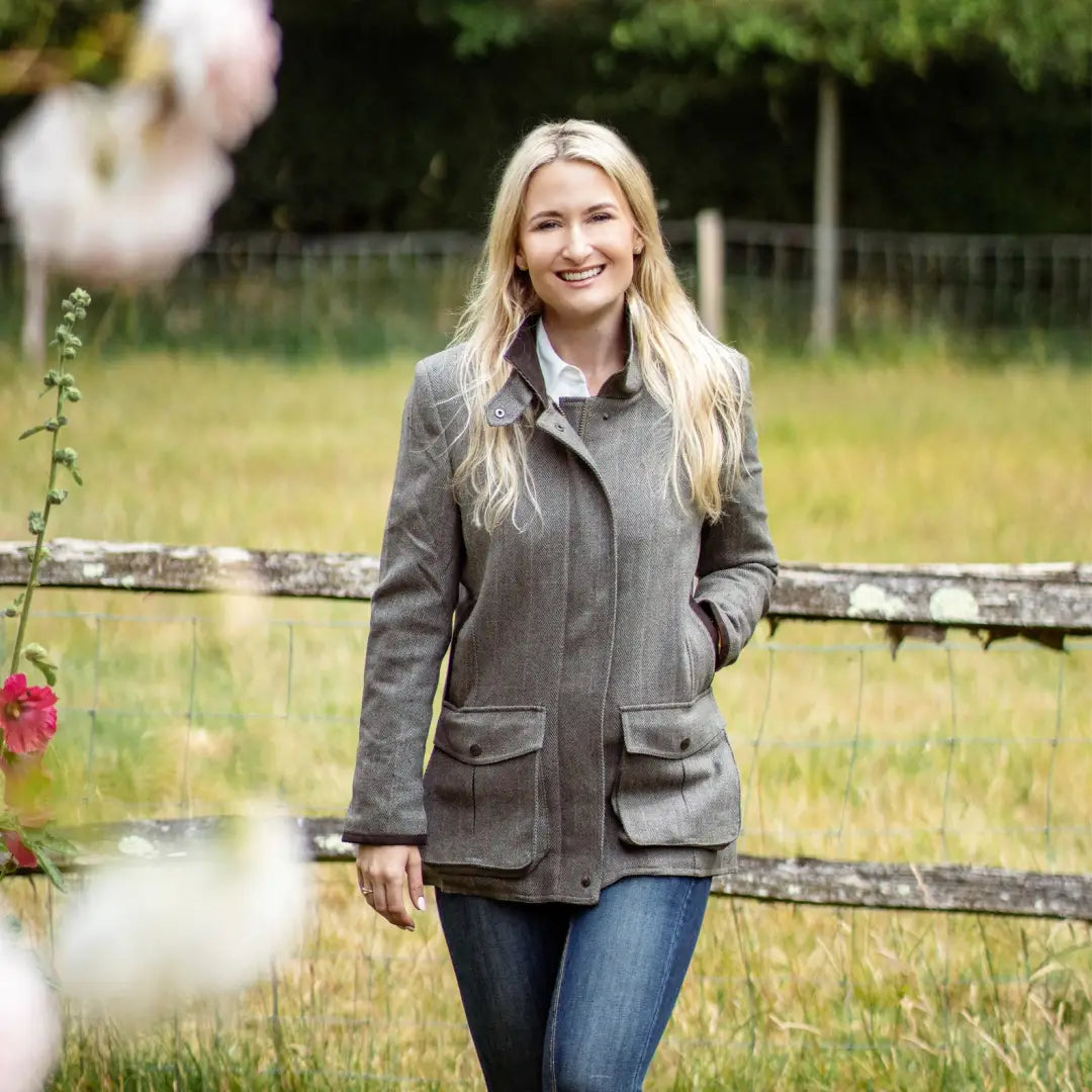 Woman in gray jacket and jeans showcasing Forest Jessica Tweed Field Coat outdoors