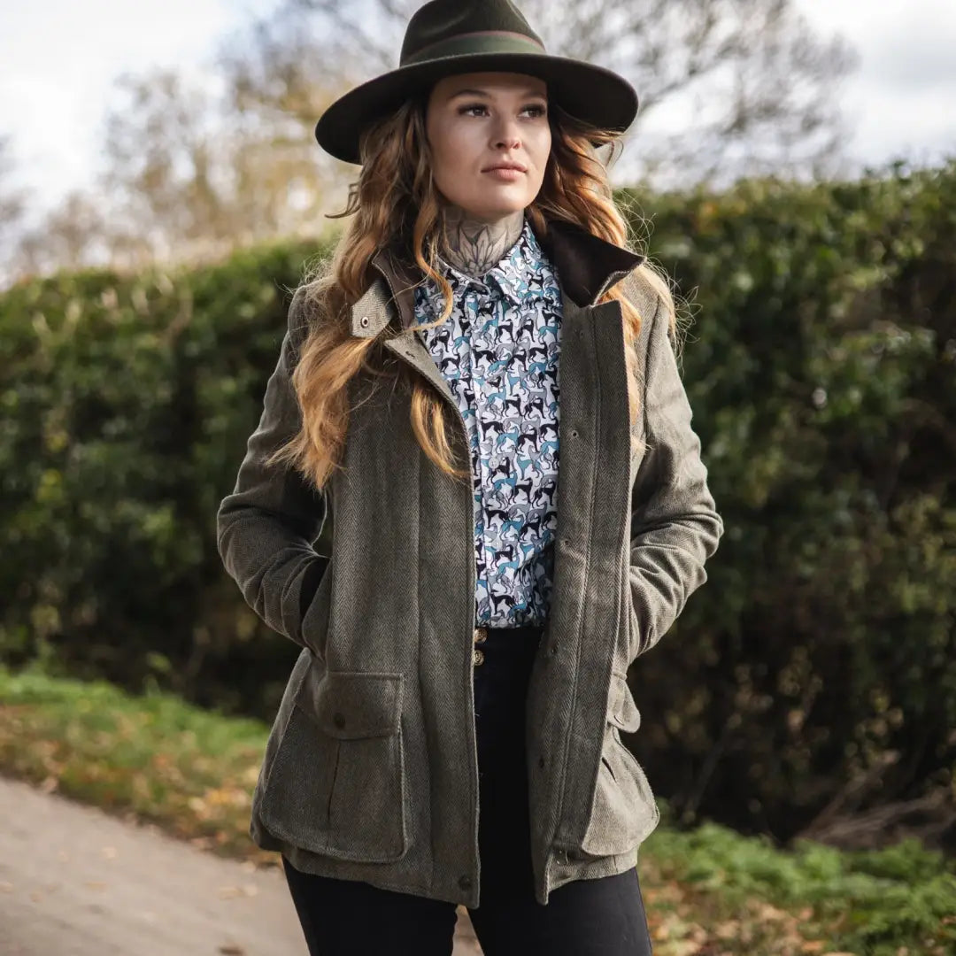 Woman in a wide-brimmed hat models the New Forest Jessica Tweed Field Coat outdoors