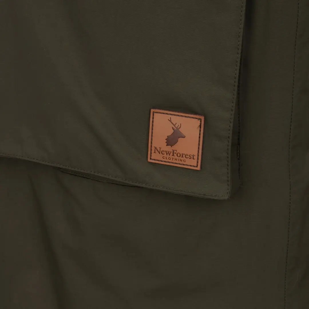 Leather patch with deer logo and New Forest text on dark green Ladies Arctic Parka