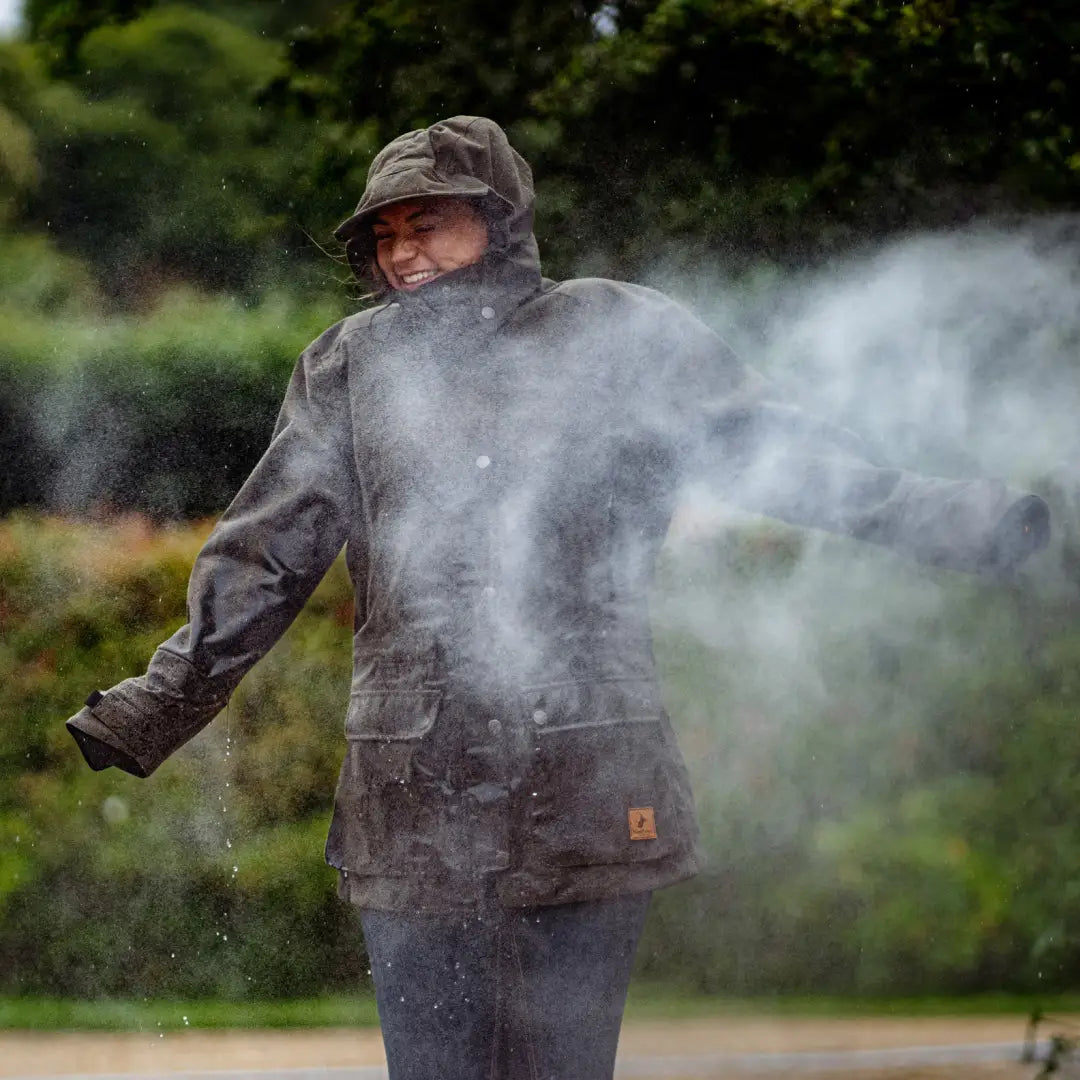 Person in a hooded raincoat in mist, wearing a New Forest Ladies Country Sport Jacket