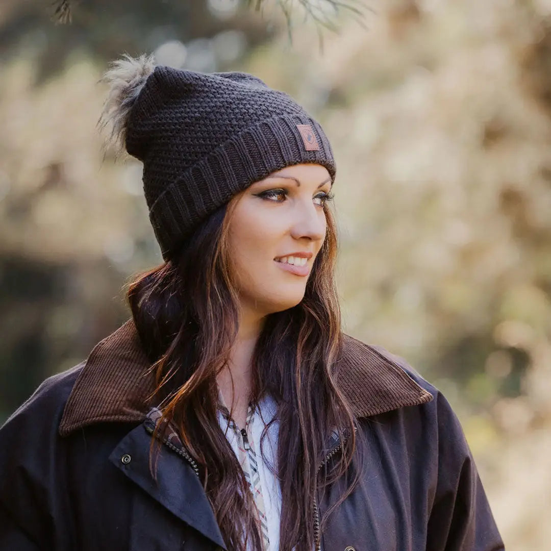 Woman stylishly rocking a New Forest Ladies Knitted Hat with a dark knit beanie