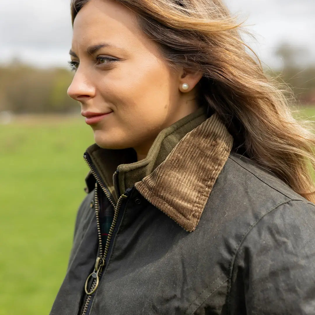 Woman in a wax jacket with blonde hair, perfect for country clothing and hunting