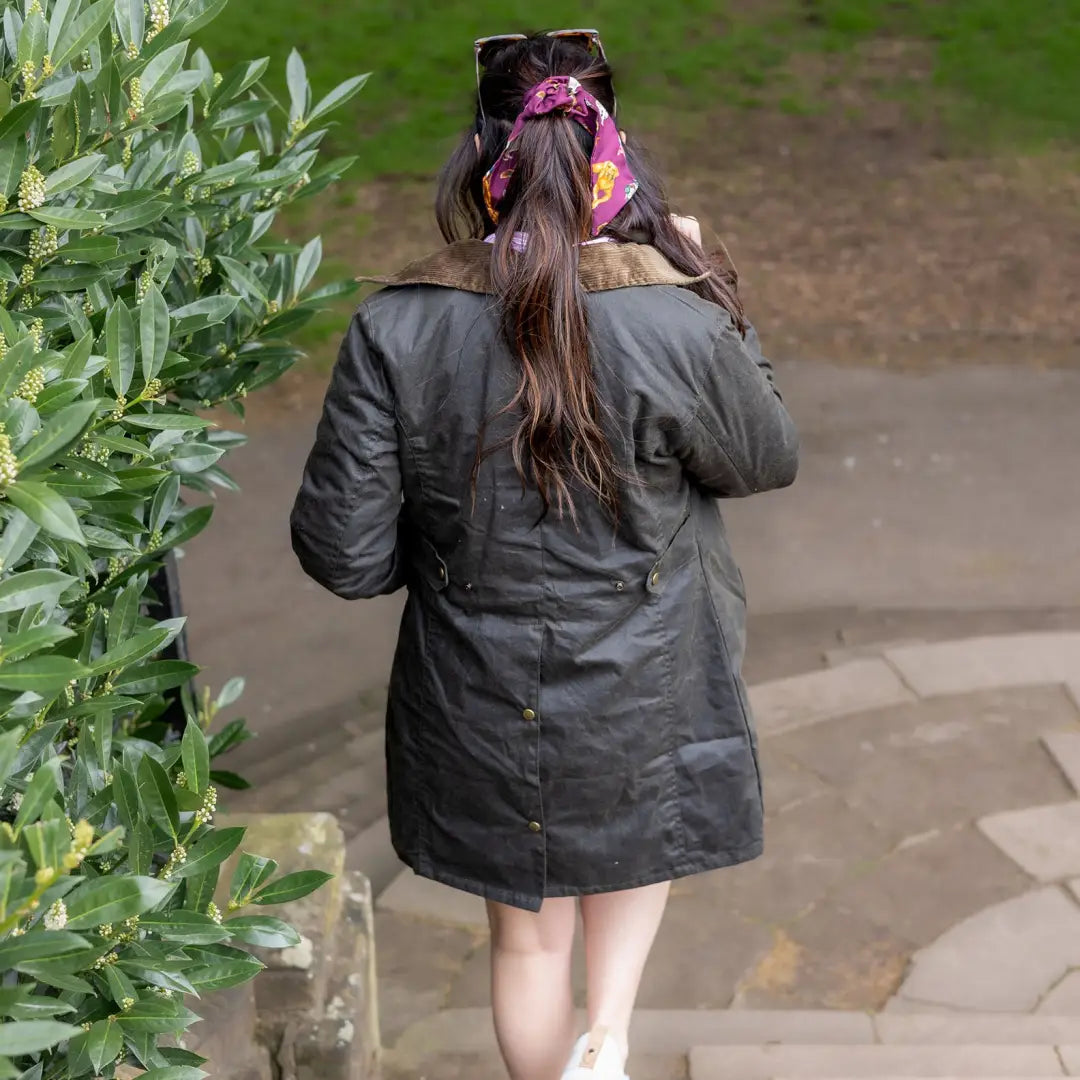 Woman in black coat showcasing the New Forest Wax Jacket for stylish country clothing