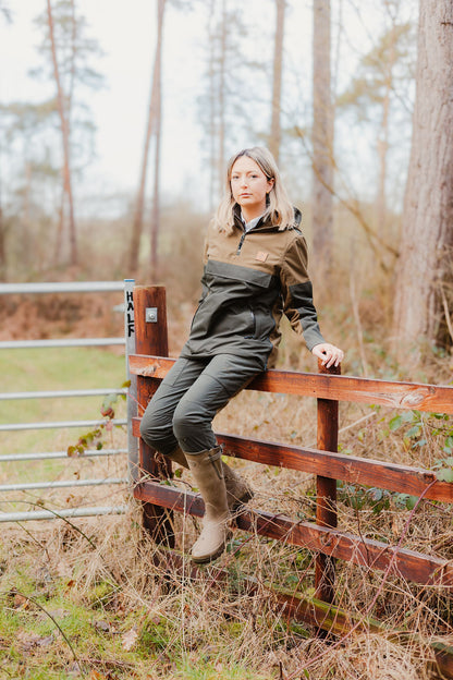 Woman in the New Forest Ladies Nightjar Smock sitting on a wooden fence outdoors