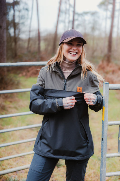 Smiling woman in a two-tone anorak wearing the New Forest Nightjar Smock