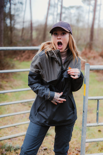 Woman in outdoor clothing looking surprised in a New Forest Nightjar Smock