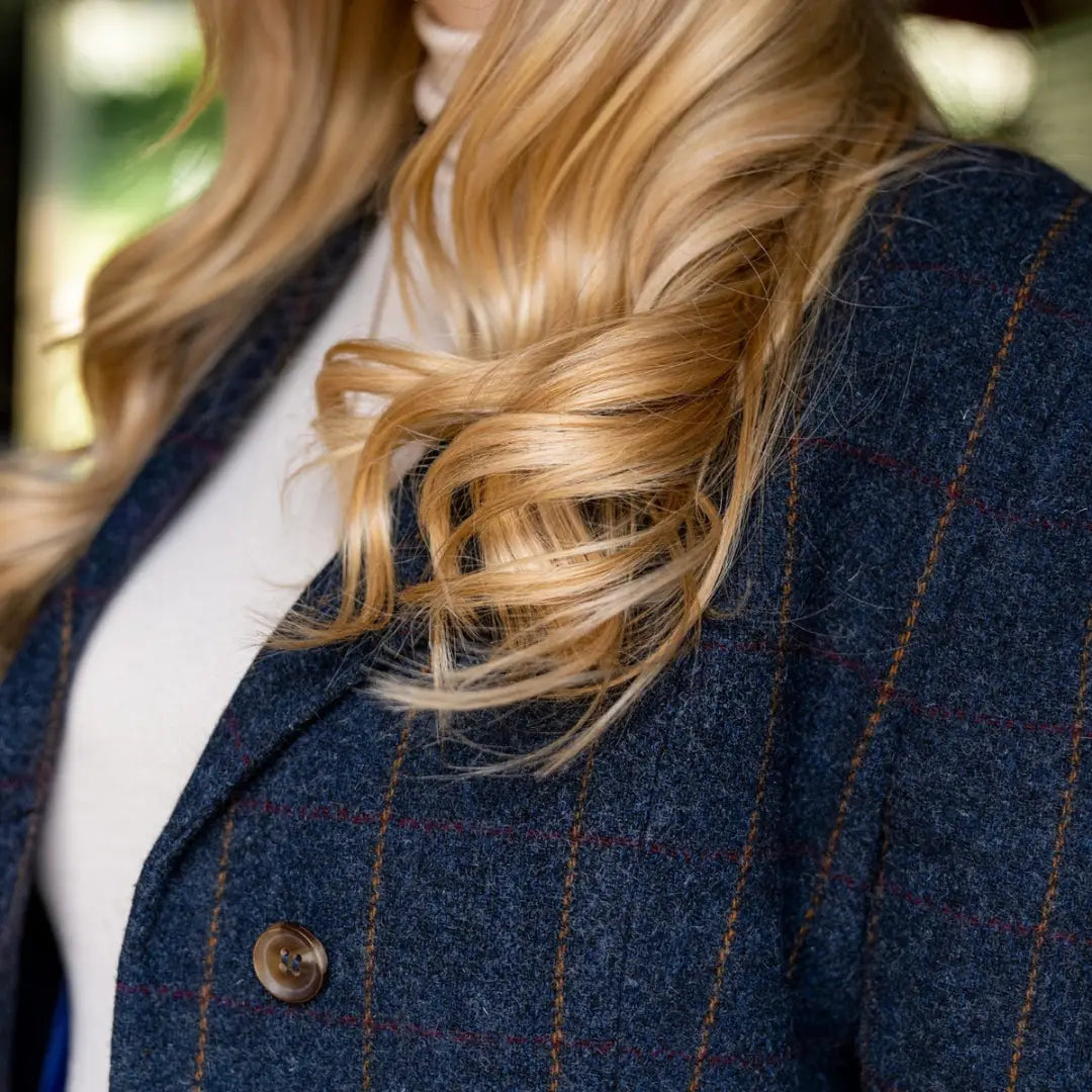 Navy blue plaid Lizzie Tweed Coat with blonde hair draped over the lapel