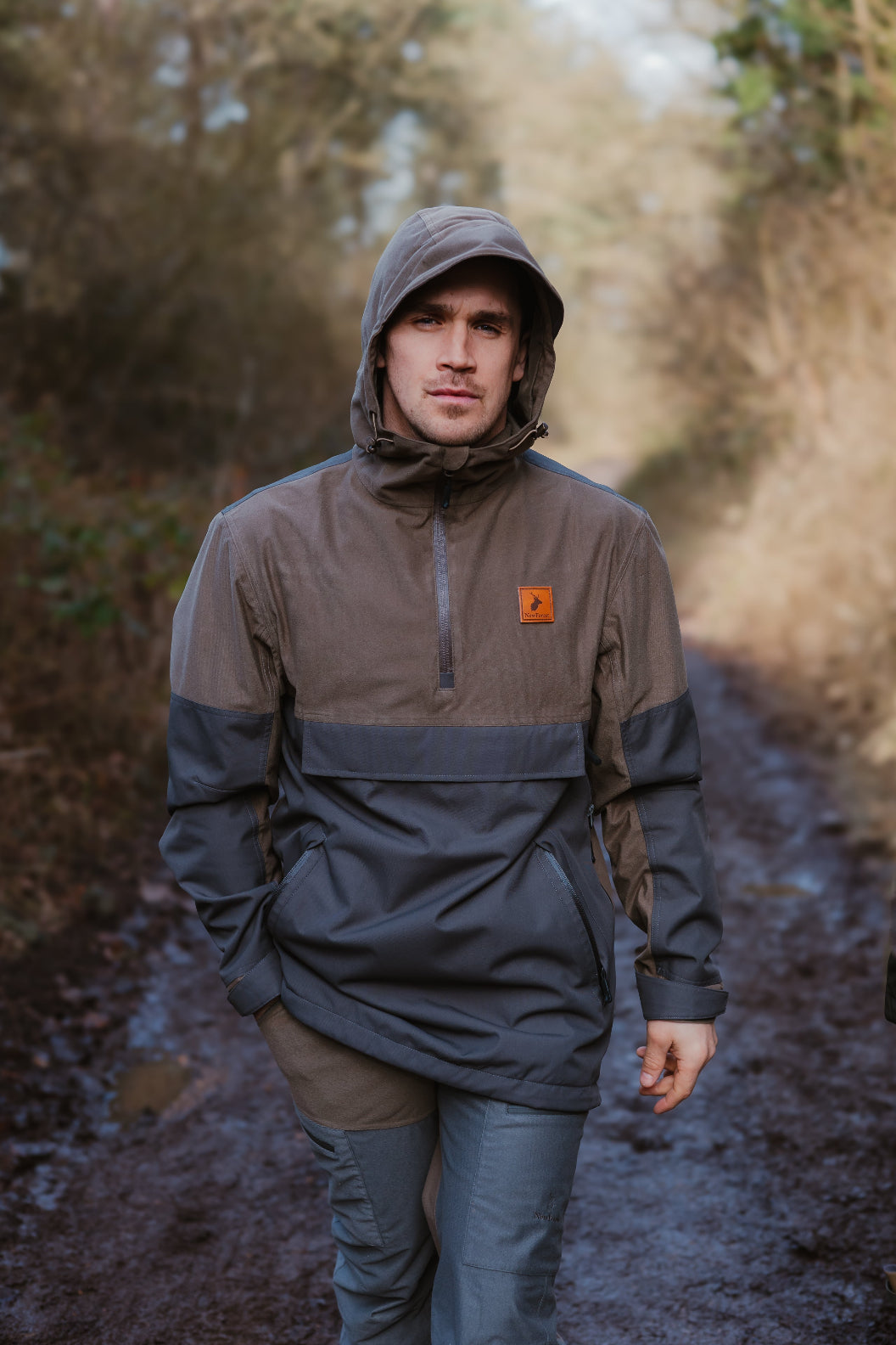 Man in hooded anorak wearing the stylish Forest Nightjar Smock outdoors