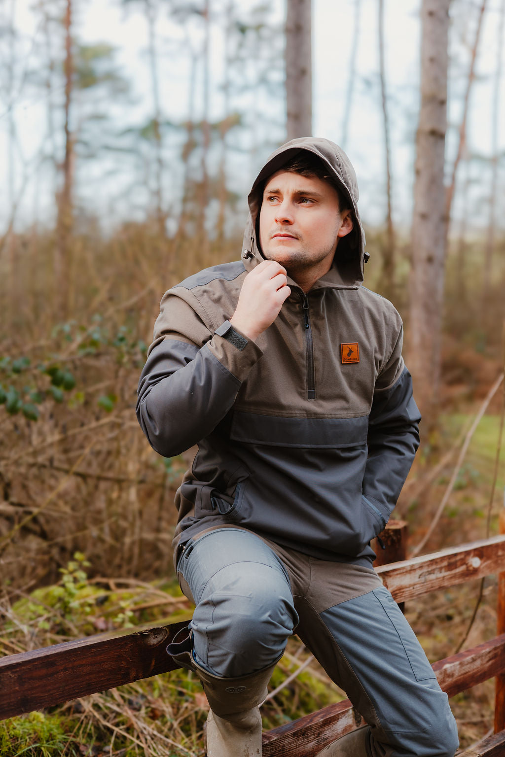 Man in hooded anorak and pants wearing Forest Nightjar Smock for outdoor adventures