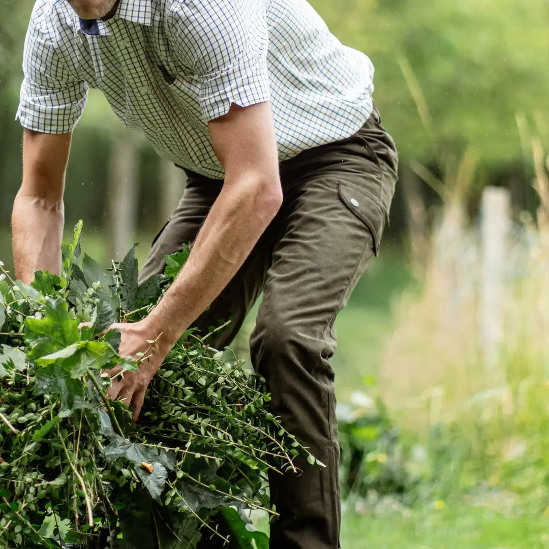 Person harvesting leafy greens wearing New Forest Performance Field Trousers