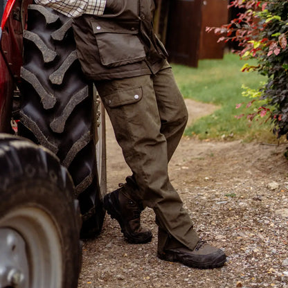 Tractor tire with deep treads beside legs in New Forest Performance Field Trousers