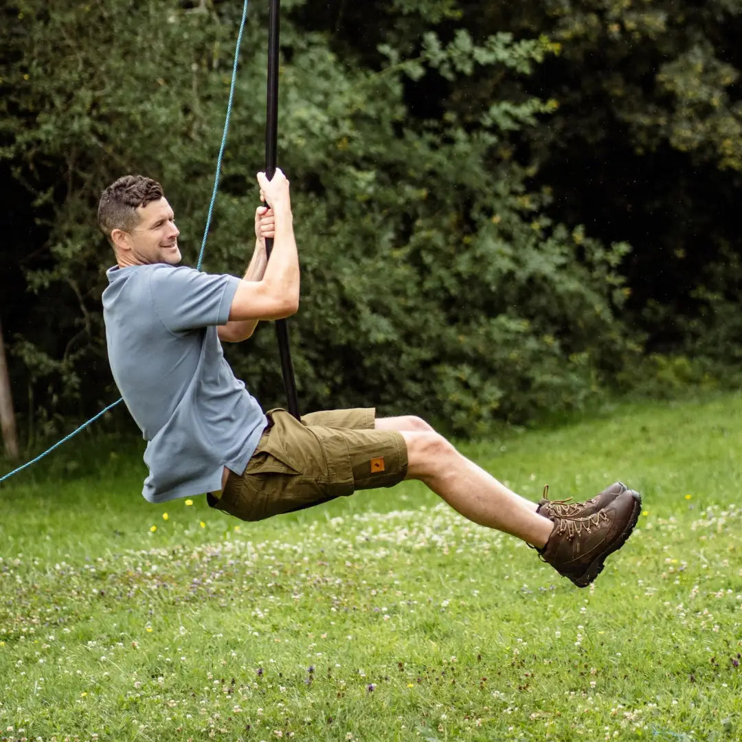 Man enjoying the outdoors in a stylish New Forest Pique Polo Shirt on a rope swing