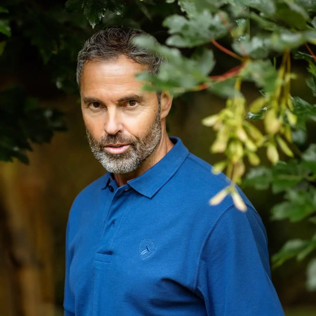 Middle-aged man with salt-and-pepper beard models New Forest Pique Polo Shirt