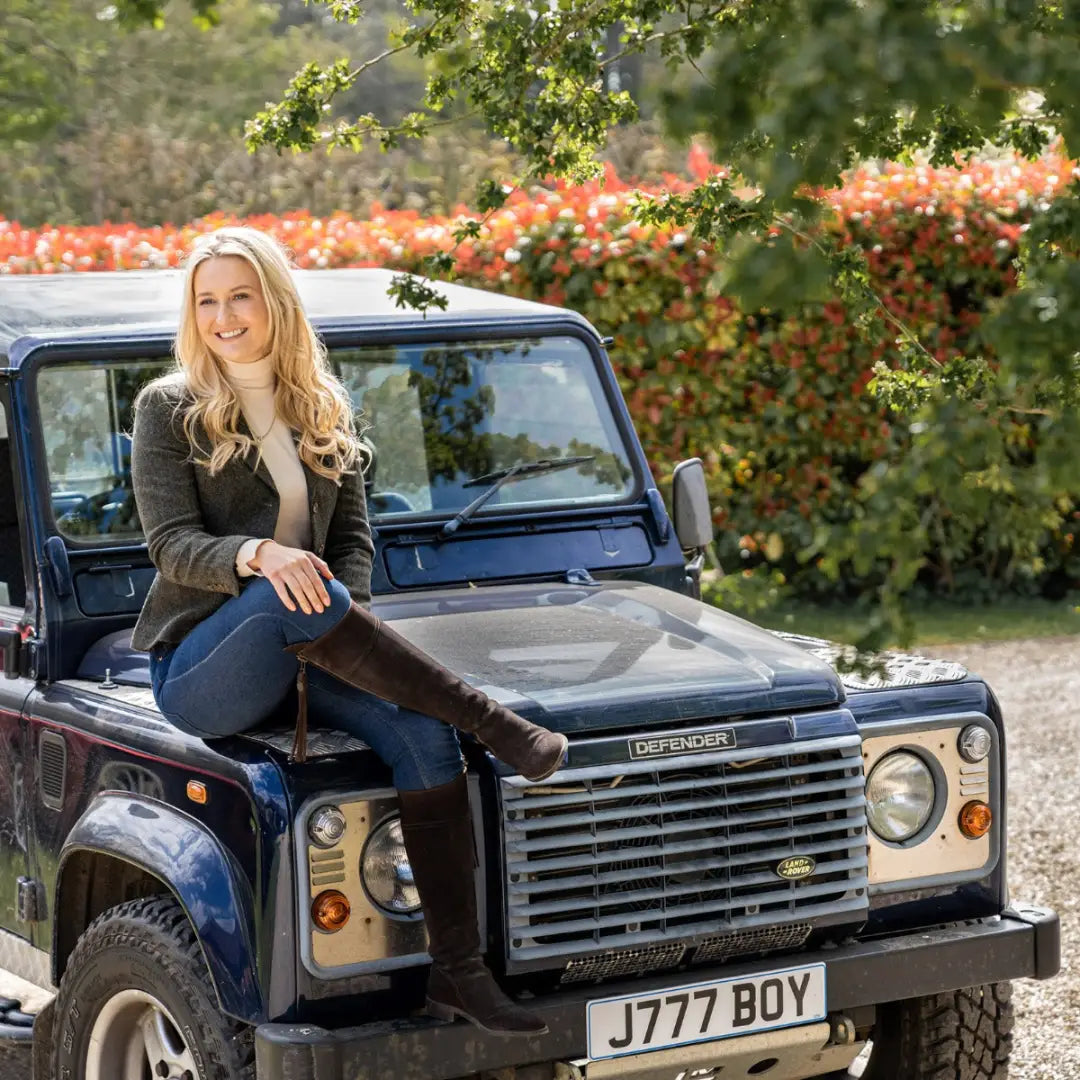 Land Rover Defender with person on hood, styled with the Polly Tweed Blazer