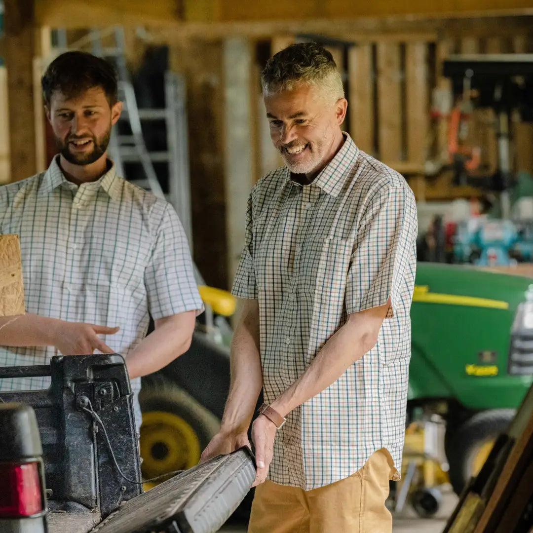 Two men in a workshop wearing New Forest Premium short sleeve country clothing