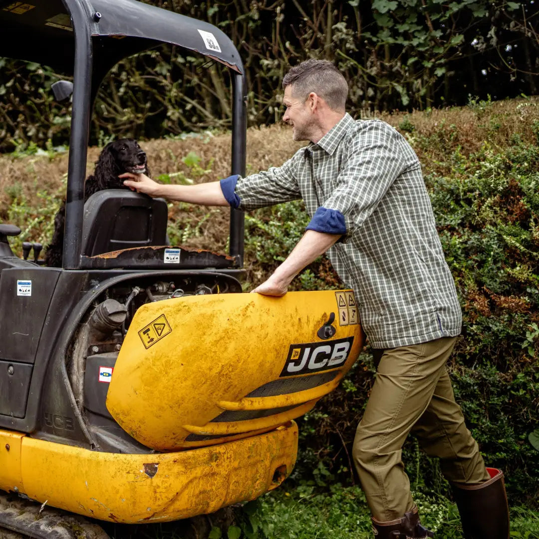 Yellow JCB mini excavator in action, ideal for outdoor work with a premium fleece lined shirt