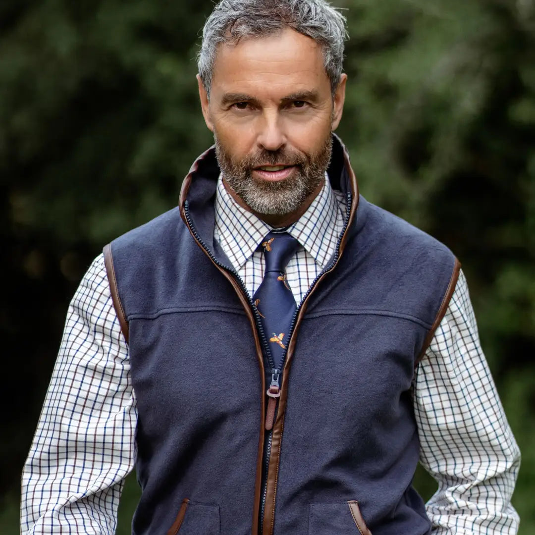 Middle-aged man in a Navy vest showcasing a New Forest Premium Tattersall Shirt