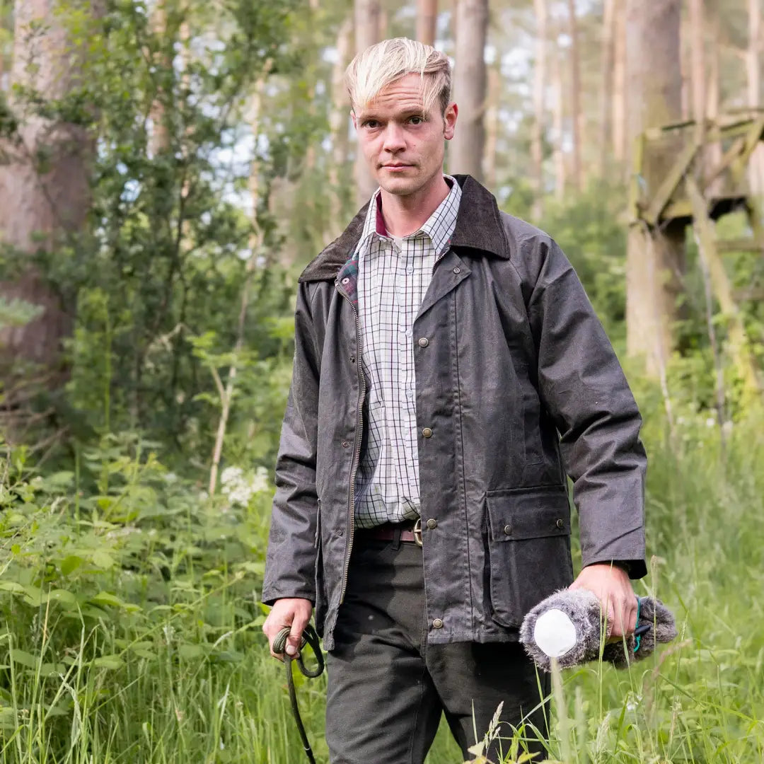 Man in dark jacket and plaid New Forest Premium Tattersall Shirt in woods