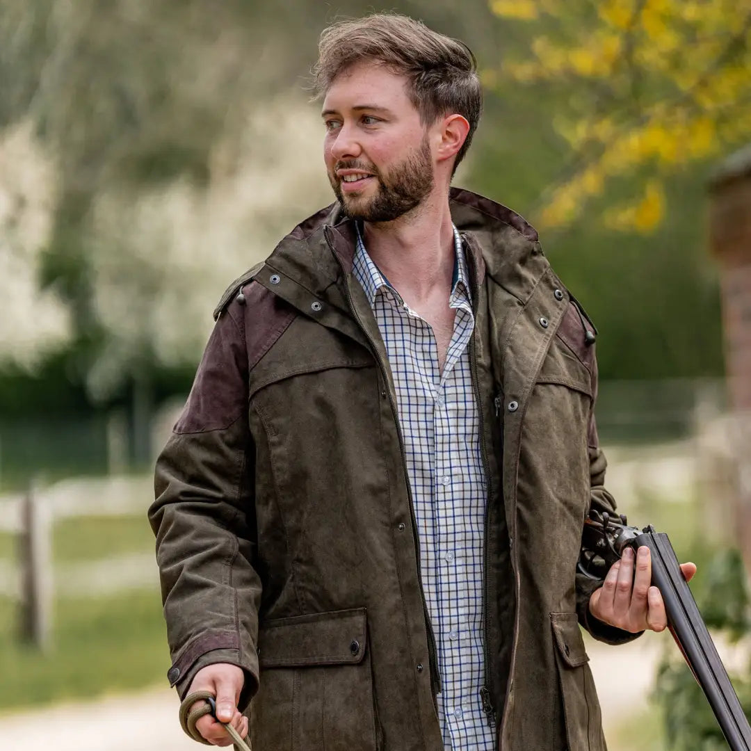 Man in brown jacket and plaid New Forest Premium Tattersall Shirt with shotgun