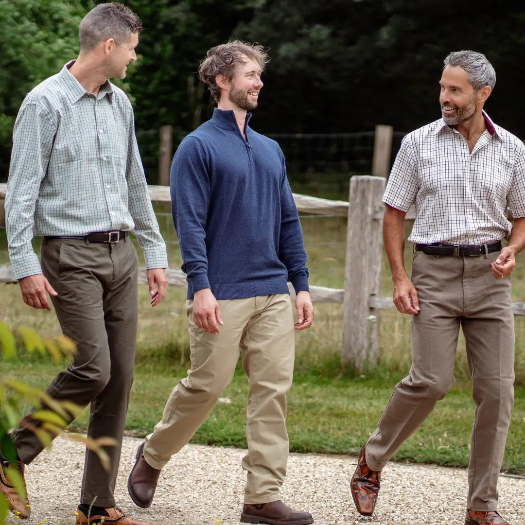 Three men in a Forest Premium Tattersall Shirt walking on a scenic outdoor path