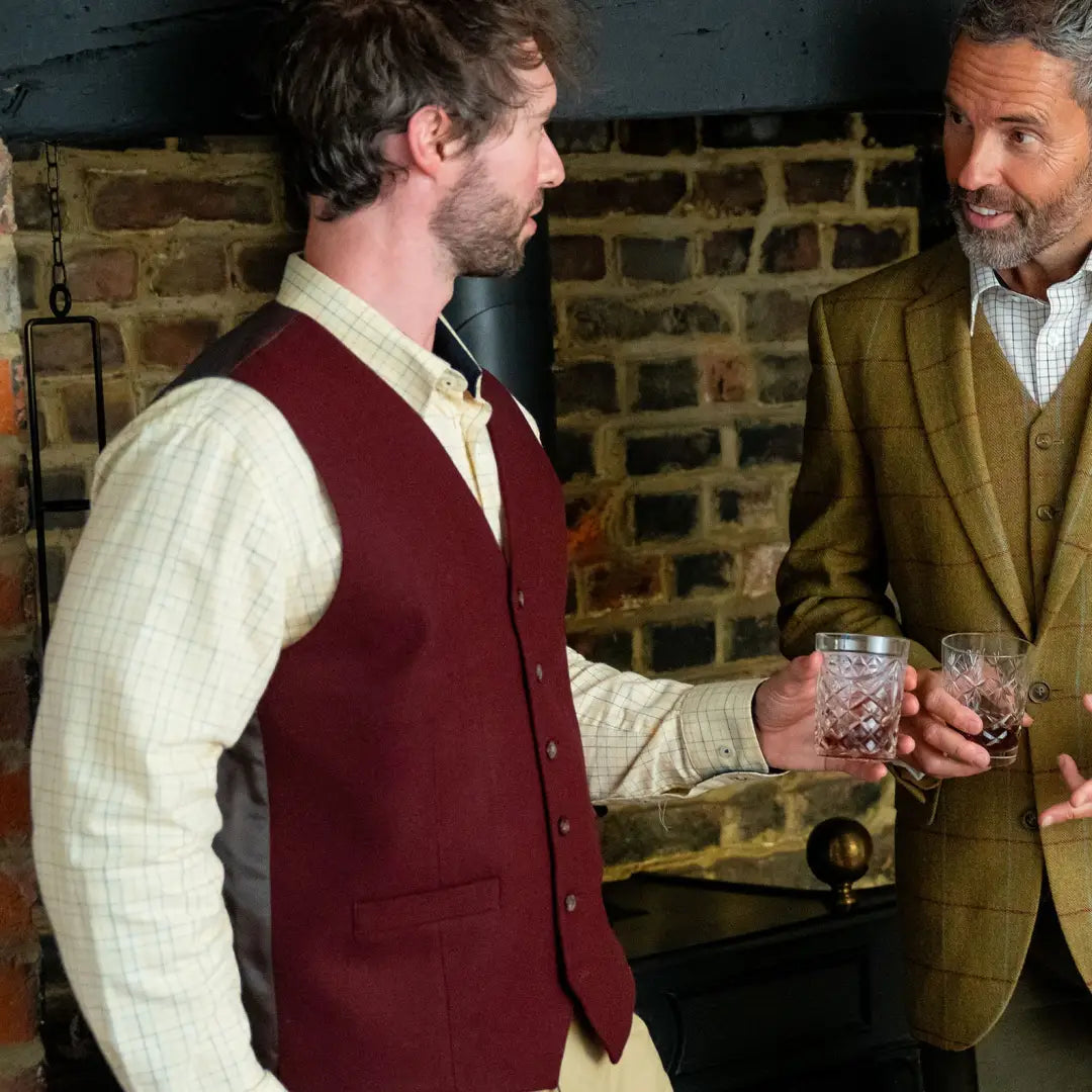 Two men chatting over drinks while wearing a New Forest Premium Tattersall Shirt made of premium quality cotton