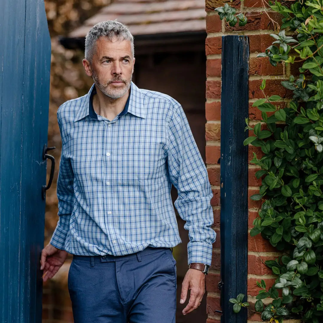 Middle-aged man in blue checkered New Forest premium tattersall shirt and navy pants