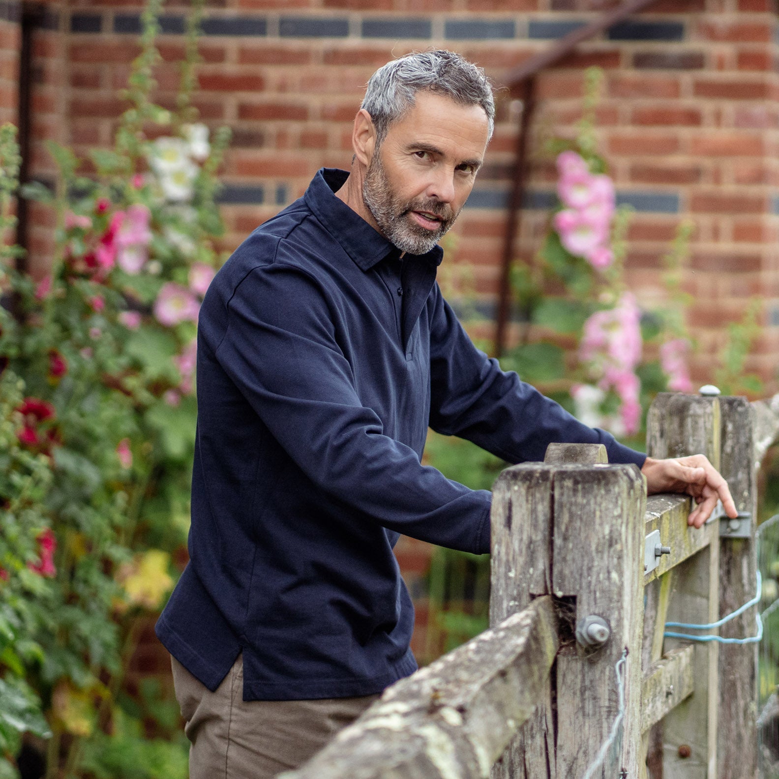 Man in navy collared shirt wearing a New Forest Rugby Shirt with braided twill collar