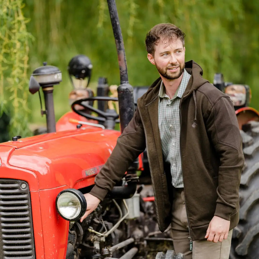 Red vintage tractor with a person, showcasing the New Forest Stag quality poly cotton hoodie