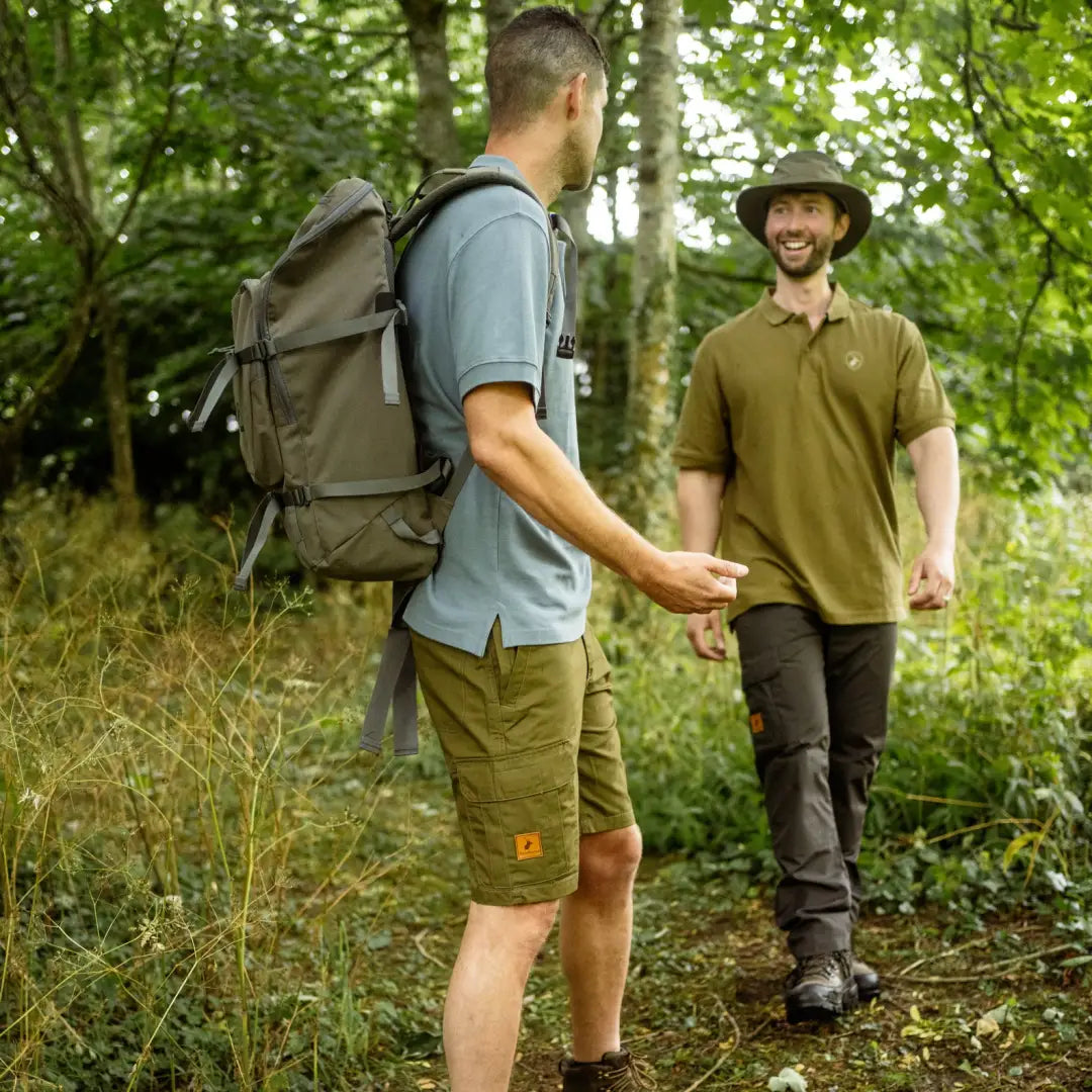 Two hikers chatting on a forest trail in stylish Forest Trail Shorts