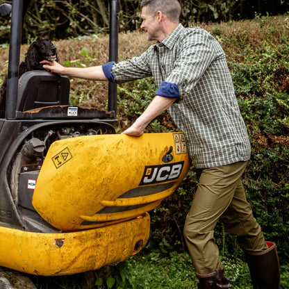 Yellow JCB mini excavator beside New Forest Trail Trousers for outdoor adventures