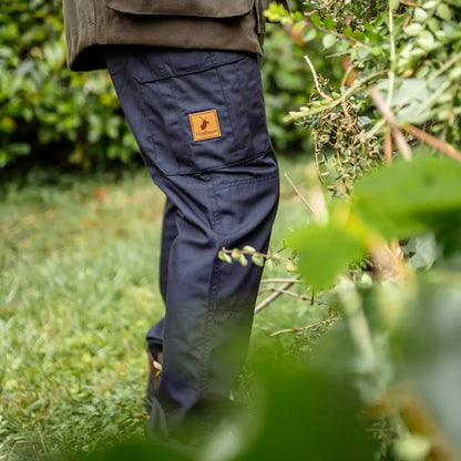 Navy blue forest trail trousers with an orange logo patch on the thigh