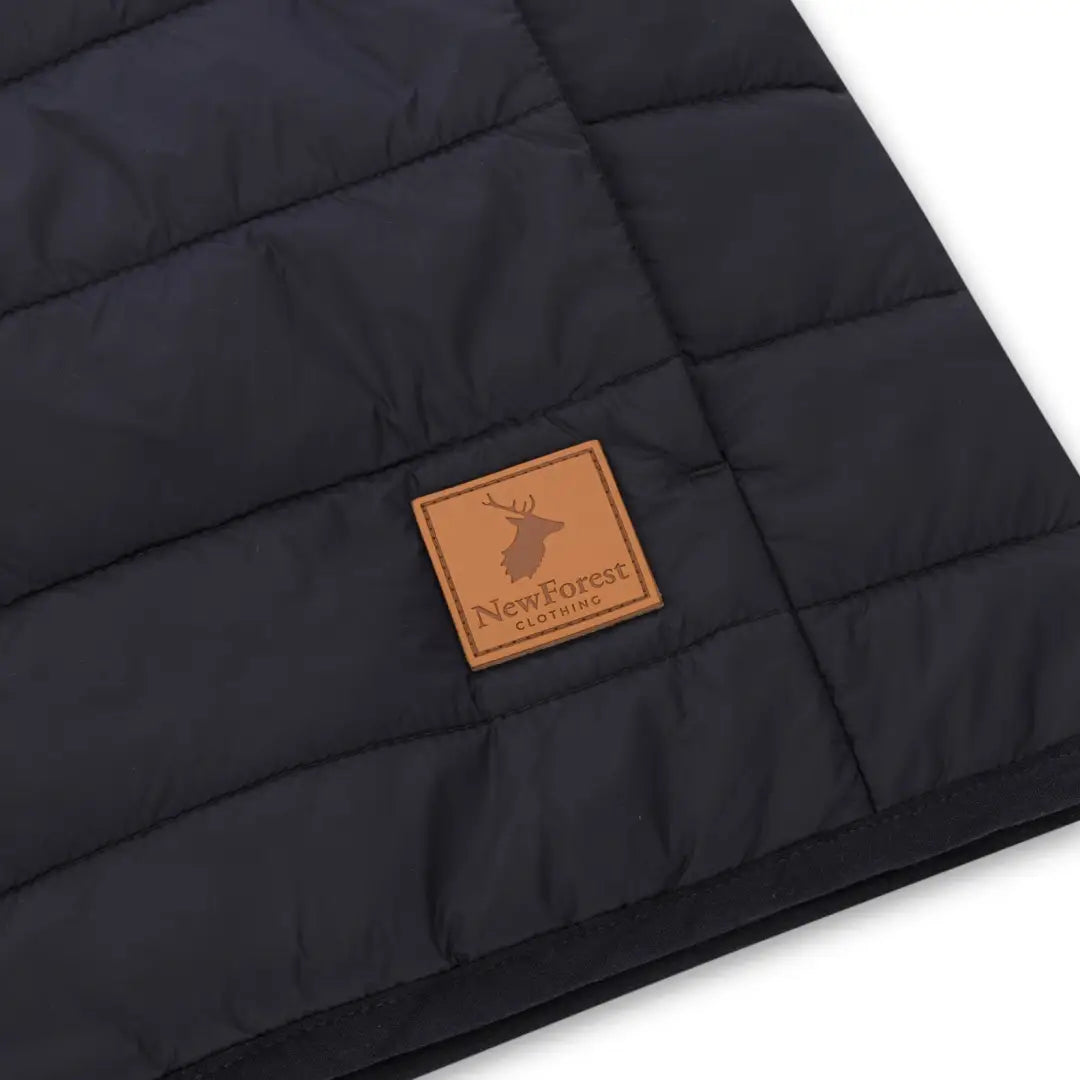 Quilted black fabric with leather patch and deer logo on New Forest Trek Jacket