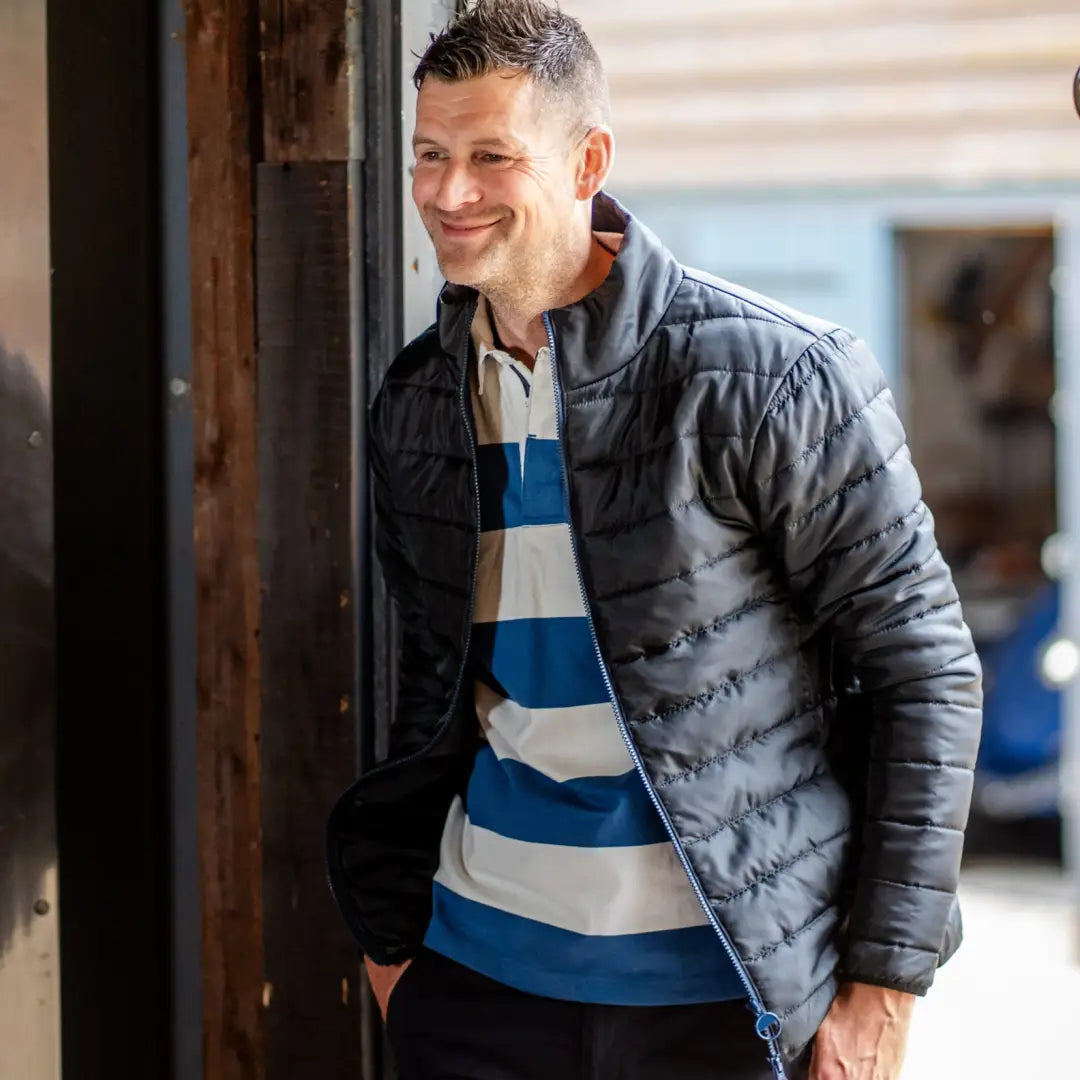 Man in a blue and white striped shirt with a gray Puffy Forest Trek Jacket